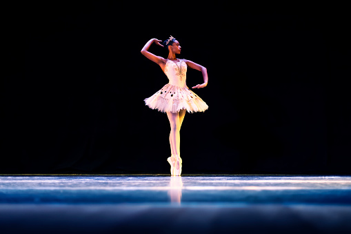 Black girl dancing Raymonda ballet on stage