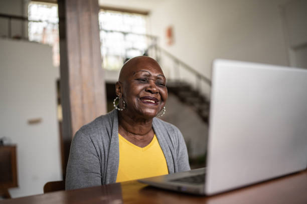 istock Senior woman using the laptop at home 1390898542