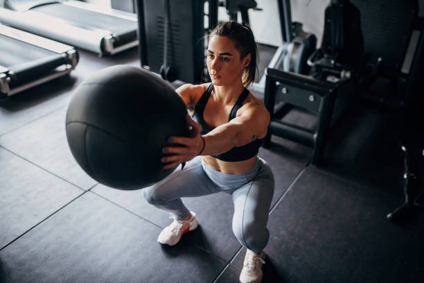istock Fit woman training with medicine ball 1390898572