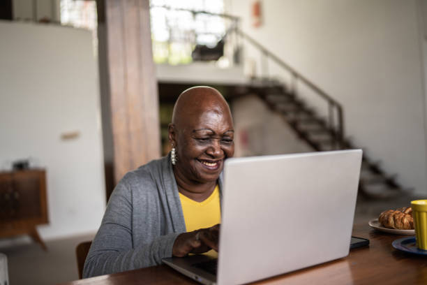 istock Senior woman using the laptop at home 1390898576