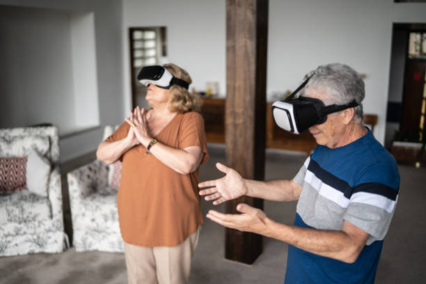 istock Senior couple using virtual reality glasses at home 1390898662