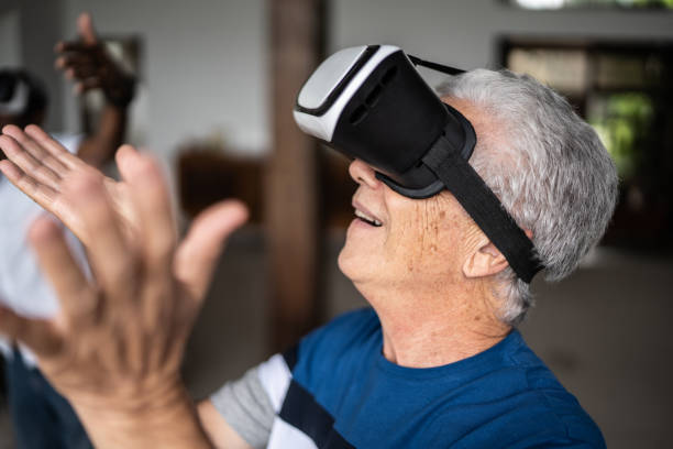 istock Seinor man using a virtual reality glasses at home 1390898710