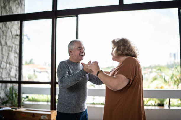 istock Happy senior couple dancing at home 1390899493