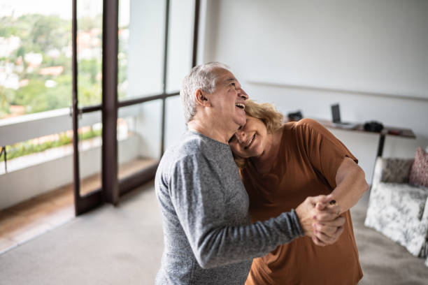 istock Happy senior couple dancing at home 1390899507