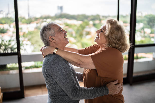 istock Happy senior couple dancing at home 1390899519