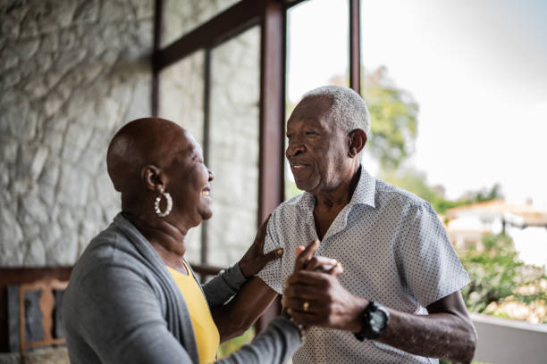 istock Happy senior couple dancing at home 1390899566