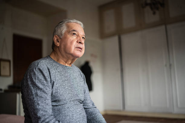 istock Senior man sitting on the bed and looking away 1390899605