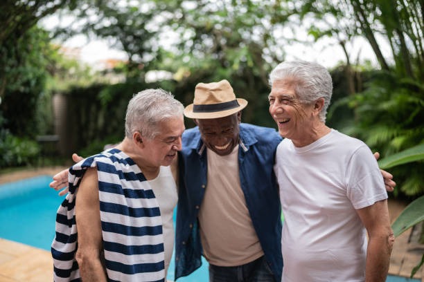 istock Senior men embracing on a pool party 1390899964
