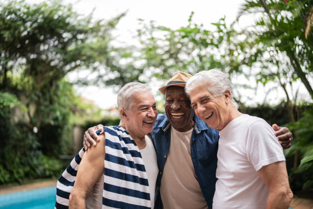 istock Senior men embracing on a pool party 1390899973