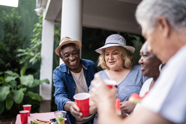 istock Senior friends drinking and having fun on a pool party 1390900113