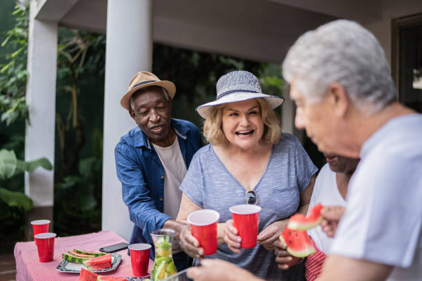 istock Senior friends eating and drinking on a pool party 1390900115
