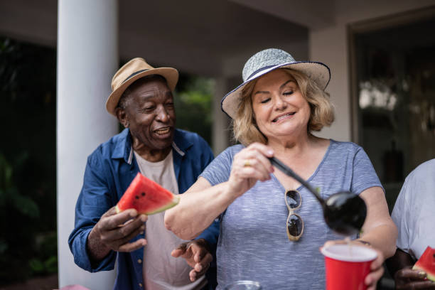 istock Senior friends eating and drinking on a pool party 1390900117