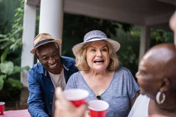 istock Senior friends drinking and having fun on a pool party 1390900126
