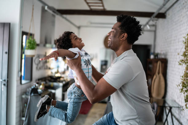 istock Happy father and son playing at home 1390900995