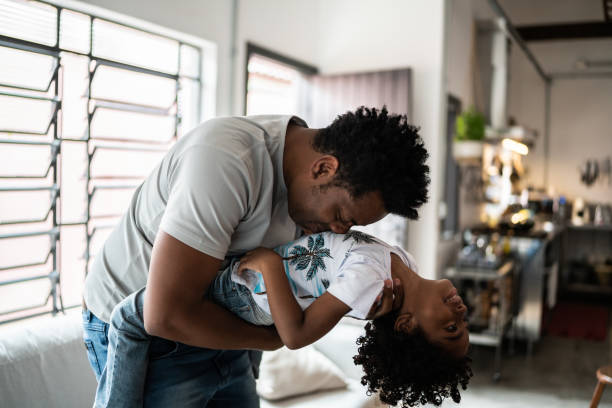istock Happy father and son playing at home 1390901150