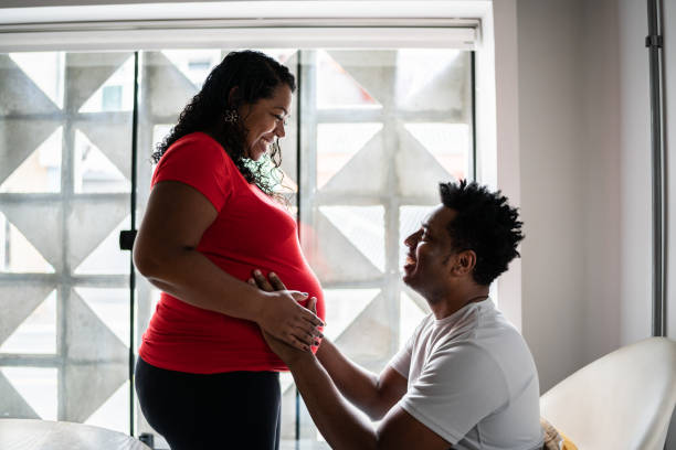 istock Husband holding pregnant wife's stomach 1390901185