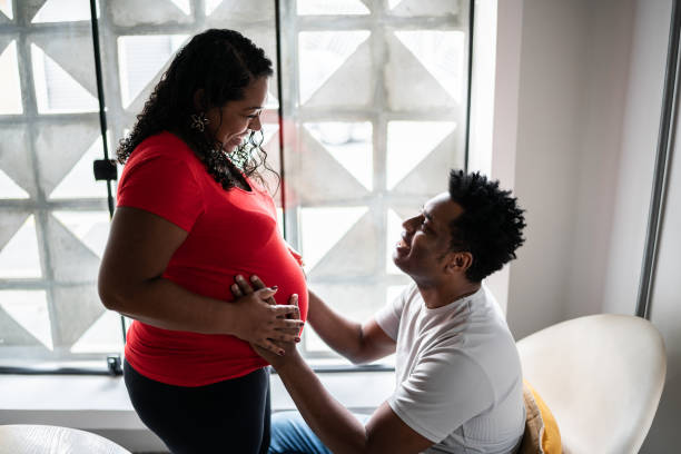 istock Husband holding pregnant wife's stomach 1390901194