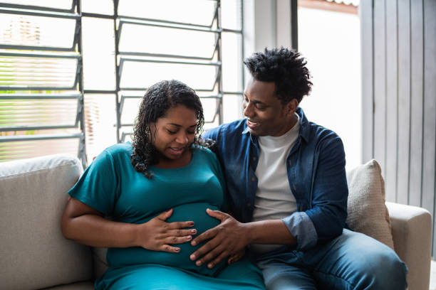 istock Couple touching her pregnant belly at home 1390901868