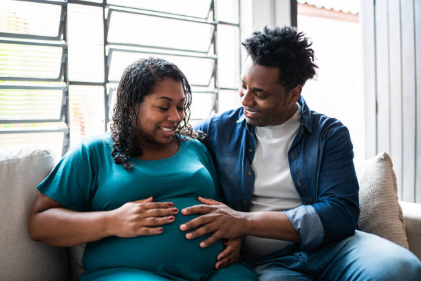 istock Couple touching her pregnant belly at home 1390901878