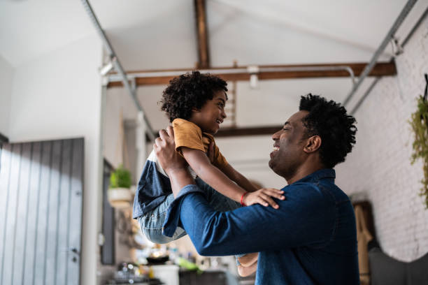 istock Father and son playing at home 1390901911