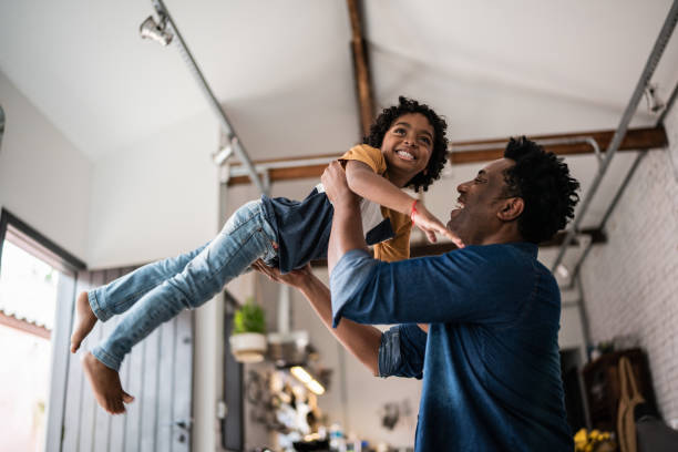 istock Father and son playing at home 1390901915