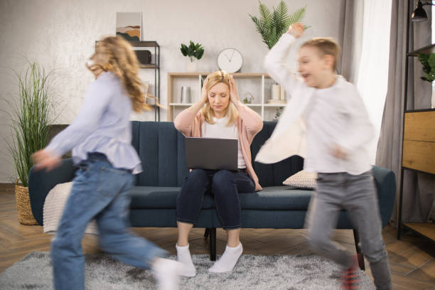 istock Frustrated stressed mom having headache feel tired annoyed about noisy active kids playing at home 1390902130