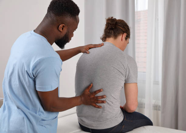Chiropractic or Osteopathy treatment, Back pain relief. Physiotherapy for male patient. stock photo