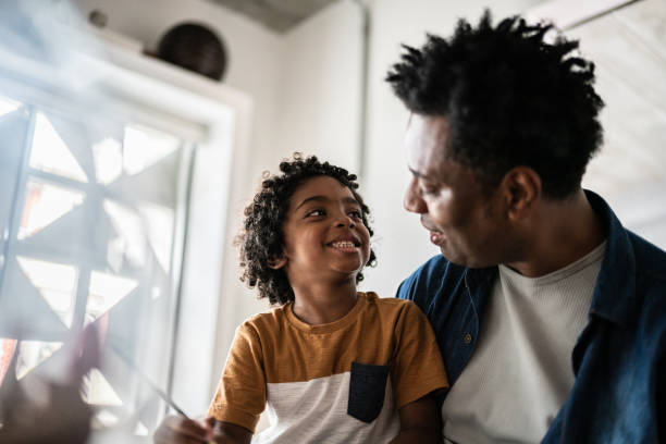 istock Father helping son drawing or writing at home 1390902744