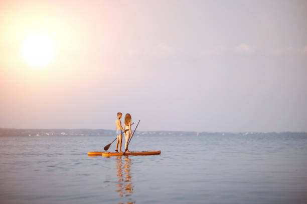istock young people traveling along the river on SAP boards 1390902949