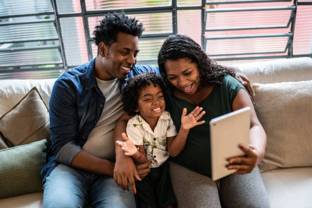 istock Family doing a video call using digital tablet at home 1390903019