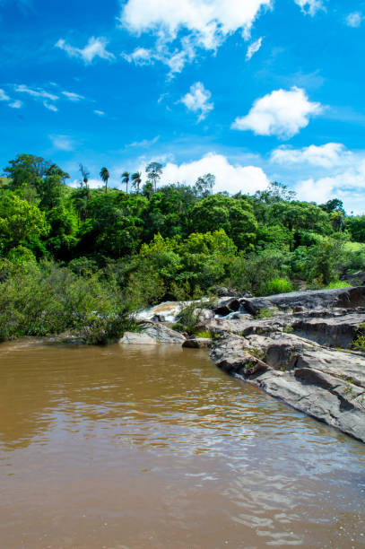 istock Beautiful landscape with waterfall, blue sky, trees, rivers, mountains and clouds. 1390903099