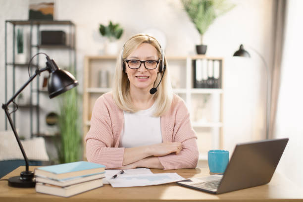 istock Female freelancer or manager sitting at workplace and looking at the camera. 1390903261