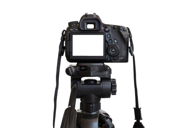 istock Dslr camera with white screen on the tripod isolated on white background. White screen camera 1390903654