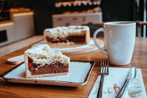Coffee with apple pie and cake served in cafe, pie and coffee on wooden background