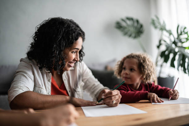 istock Mother and daughter drawing at home 1390904921