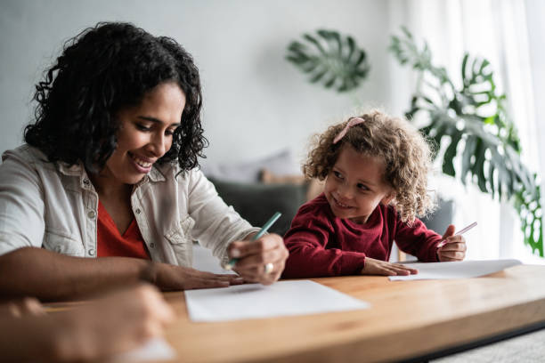 istock Mother and daughter drawing at home 1390904936