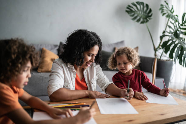 istock Mother and children drawing at home 1390904938