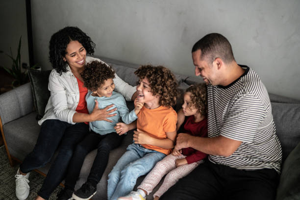 istock Family having fun on sofa at home 1390904949