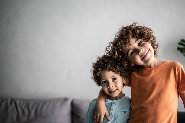 Portrait of two brothers at home Portrait of two brothers at home sibling stock pictures, royalty-free photos & images