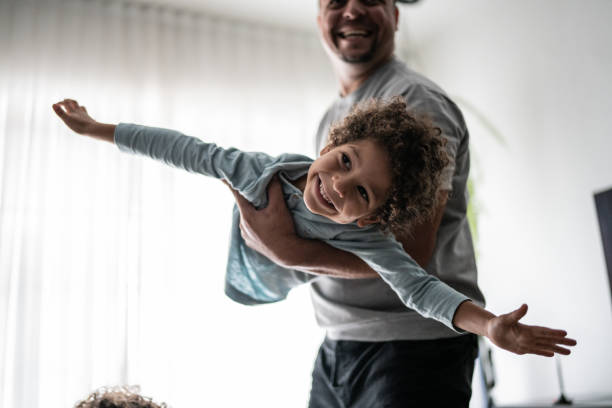 istock Father playing with son at home 1390905654