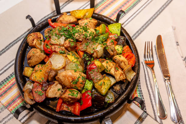 istock Pan-fried potatoes, meat and vegetables for a large company 1390905976