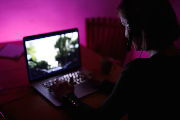 istock Woman playing a fun, interactive video game on laptop late at night 1390906073