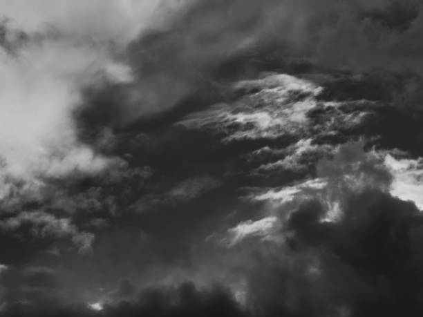 istock dramatic sky, with ghostly white clouds floating above dark clouds in varying shades of gray. 1390906450