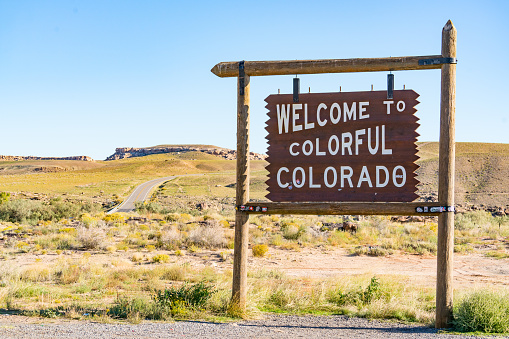 Teec Nos Pos, AZ - October 10,2021:  Welcome to Colorado sign along the road at the state border in Teec Nos Pos, Arizona