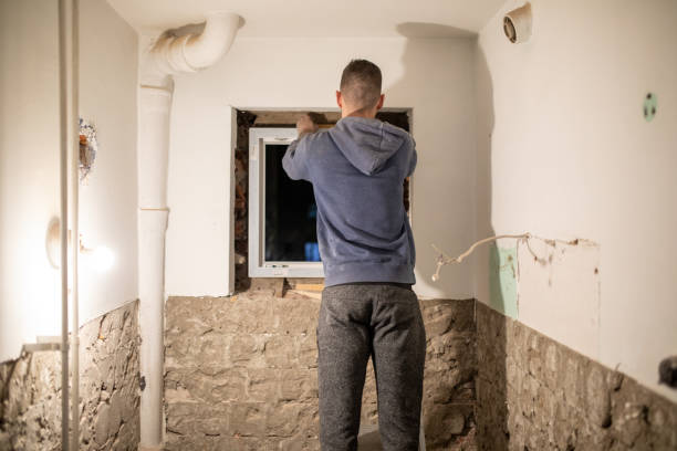 istock Back shot of a young construction worker installing PVC window 1390907087