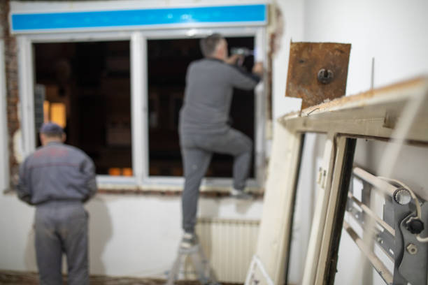 istock Back shot of construction workers installing pvc windows in aparment 1390907201