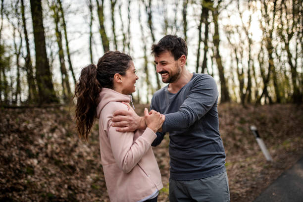 istock Happy athletic couple having fun while running in spring day 1390908268