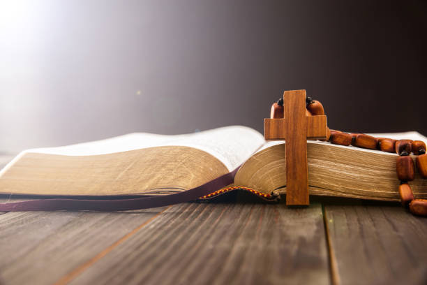 istock Holy Bible with wooden cross 1390909366
