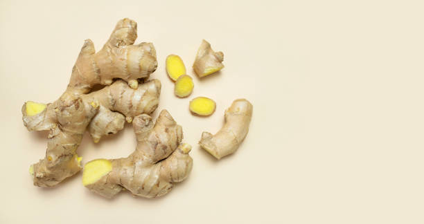 istock Fresh ginger root chopped ginger pieces on beige background top view flat lay. Spice for cooking, herbal tea with ginger to boost immunity. Natural organic ginger for health medicine protection colds 1390909474