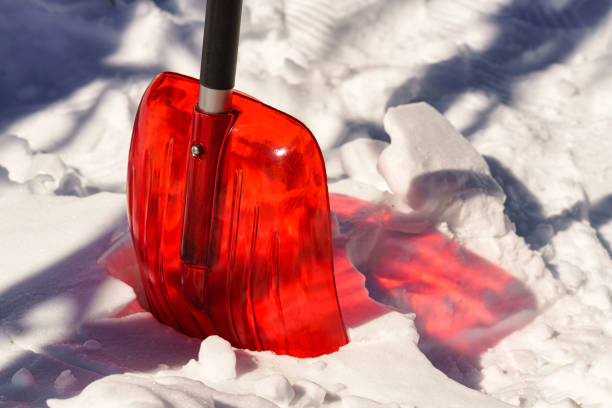 Red Snow Shovel with Light Shining Through